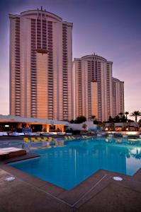 a large swimming pool in front of some tall buildings at MGM SIGNATURE - Balcony Suite Strip View - FREE valet parking in Las Vegas