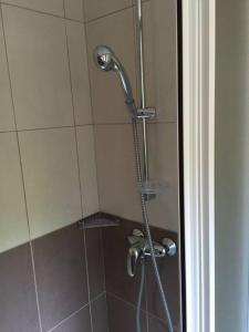 a shower with a shower head in a bathroom at Center of town rooms!No.1 in Vis