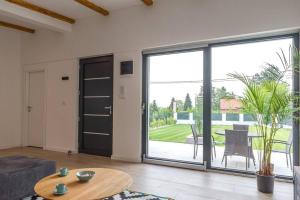 a living room with a large sliding glass door at Vikendica 137 in Smederevo