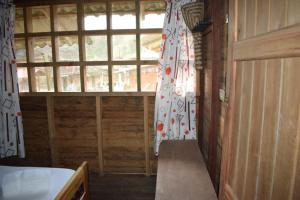 a room with a window in a wooden house at Posada Jurubirá in Nuquí +32 photos