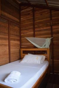En eller flere senge i et værelse på Posada Jurubirá