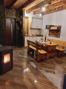 a kitchen with a table and benches in a room at Domek pod Holicą 3 Bieszczady in Ustianowa +23 photos