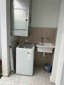 a small bathroom with a sink and a refrigerator at DON SIMON Apart 2 - departamento nuevo in Esperanza