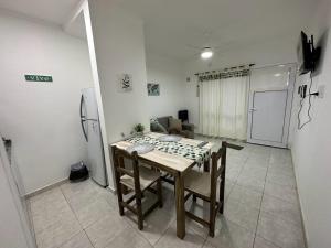 a dining room with a table and a refrigerator at DON SIMON Apart 2 - departamento nuevo in Esperanza