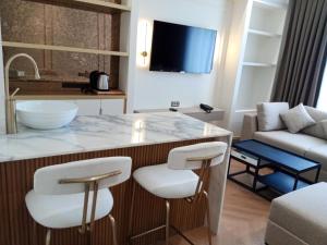 a kitchen and living room with a large island with stools at Taksim Bosphorus Hotel in Istanbul