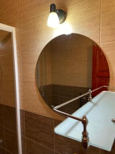 a bathroom with a mirror and a sink at Pensiunea Lavinia Daniel in Borşa