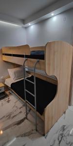 a couple of bunk beds in a room at Cozy Garden View Apartment in Paralia in Paralia Katerinis