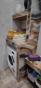 a shelf with a washing machine in a room at Cozy Garden View Apartment in Paralia in Paralia Katerinis