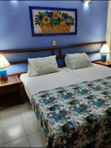 a bedroom with a bed with a floral bedspread at Condominio Girardot Resort INT 4 APTO 302 in Girardot