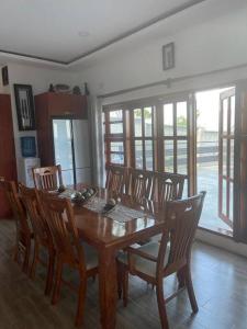 a dining room with a wooden table and chairs at Serene & quiet 2- Bedroom Cottage Statelodge area in Shimwansa