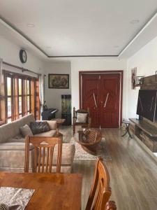 a living room with a couch and a table at Serene & quiet 2- Bedroom Cottage Statelodge area in Shimwansa