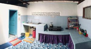 a kitchen with a stove and a counter top at Koto Hilalang Homestay in Bukittinggi
