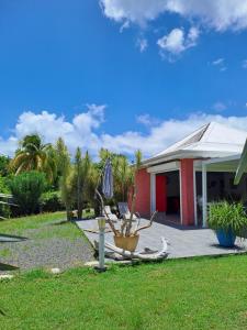 a house with a patio and a plant in a yard at Villa Jasmin in Sainte-Rose