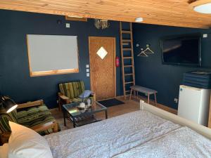 a bedroom with a bed and a blue wall at The Blue Cabin in Tyfta