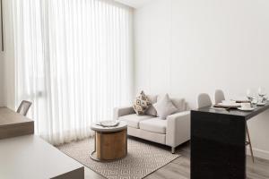 a living room with a white couch and a table at Bo Living 81 in Bogotá +21 photos