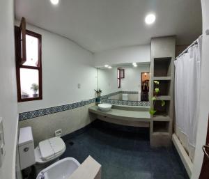 a bathroom with a tub and a toilet and a sink at Terraza de la Usina in Salta