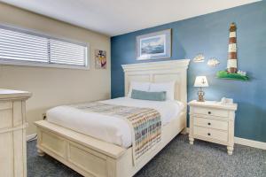 a bedroom with a bed and a lighthouse on the wall at 0312 Captains Quarters by Atlantic Towers in Carolina Beach