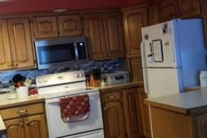 a kitchen with a white stove and a refrigerator at Entire home 5min to Senior Open+Breakfast! in Stevens Point