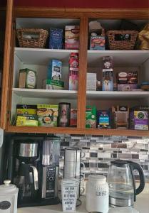 a cupboard filled with lots of food and drinks at Entire home 5min to Senior Open+Breakfast! in Stevens Point