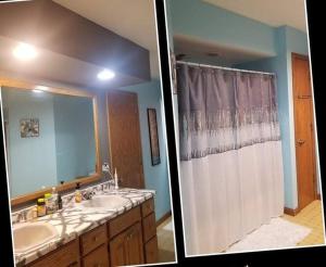 a bathroom with a sink and a shower with a shower curtain at Entire home 5min to Senior Open+Breakfast! in Stevens Point