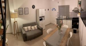 a living room with a couch and a dining room table at Cómodo depto en Comodoro Rivadavia! in Comodoro Rivadavia