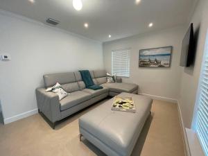 uma sala de estar com um sofá e uma mesa em Villa Capri Cottage in the heart of Miami em Miami