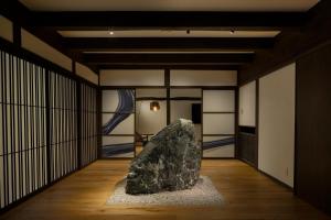 a room with a large rock on the floor at SOMA RESIDENCE HAKUBA in Hakuba