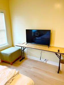 a room with a desk with a flat screen tv at BedExpress in Baltimore