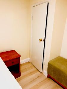 a bedroom with a door and a bed and a table at BedExpress in Baltimore