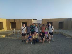 a group of people posing for a picture in front of a building at Ambigua Hospedaje in Trujillo
