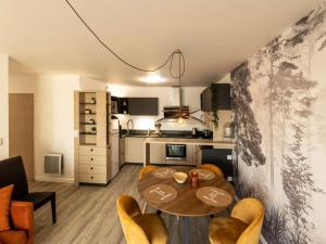 a living room with a table and chairs and a kitchen at Appartement neuf PMR, 3 pièces, centre de Saint-Pierre, 4 couchages, jardin, balcon, 3 étoiles - FR-1-246A-245 in Saint-Pierre-dʼOléron +6 photos
