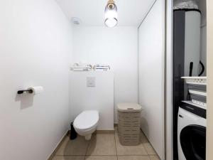 a small bathroom with a toilet and a sink at Appartement neuf PMR, 3 pièces, centre de Saint-Pierre, 4 couchages, jardin, balcon, 3 étoiles - FR-1-246A-245 in Saint-Pierre-dʼOléron