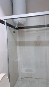 a glass shower in a bathroom with a toilet at Roli in Clorinda