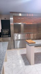 a large kitchen with a counter and a stove at Roli in Clorinda