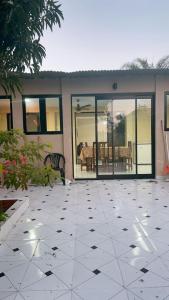a house with a large patio with glass doors at Roli in Clorinda