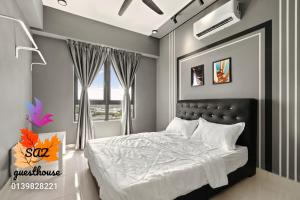 a bedroom with a large bed and a window at SAZ Guesthouse in Semenyih