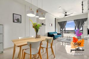 a dining room and living room with a table and chairs at SAZ Guesthouse in Semenyih