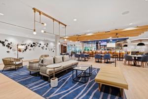 a lobby with furniture and tables and a restaurant at Sheraton Chapel Hill in Chapel Hill