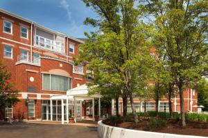 a brick building with trees in front of it at Sheraton Portsmouth Harborside Hotel in Portsmouth