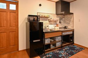 a kitchen with a sink and a counter top at Lake side inn Beehive in Kitashiobara