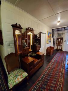 a room with a dresser and a chair and a rug at Historic Apartment in Oatlands