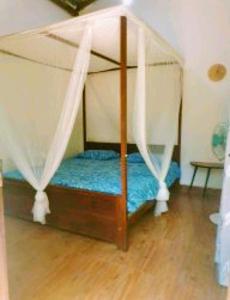 a bed with a canopy in a room at Kalimetiya Beach Cabana in Hungama