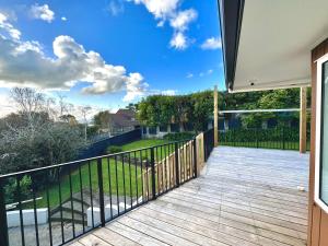 a balcony with a view of a yard at Elegant House in East Auckland in Auckland