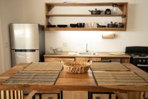 a kitchen with a wooden table and a stainless steel refrigerator at Casa Arena 2 in Big Creek