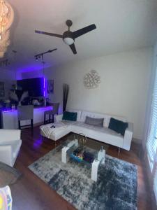 a living room with a white couch and a ceiling fan at 1Bd Gorgeous Loft in Buckhead Free Wi-Fi, Parking in Atlanta