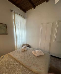 a bedroom with a bed with towels on it at la rocca sul lago in Capodimonte
