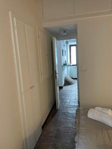 a room with a hallway with a bed and a kitchen at la rocca sul lago in Capodimonte