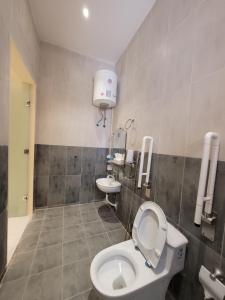 a bathroom with a toilet and a sink at لاكازا للشقق المخدومة in Riyadh