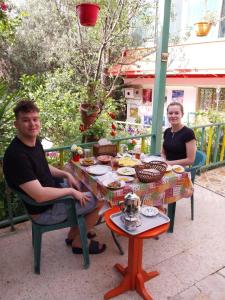 a man and a woman sitting at a table at بيت الطبيعة nature house in Jerash