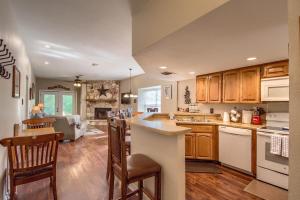 a large kitchen with wooden cabinets and a kitchen island at SS 6B Teckelhaus in New Braunfels